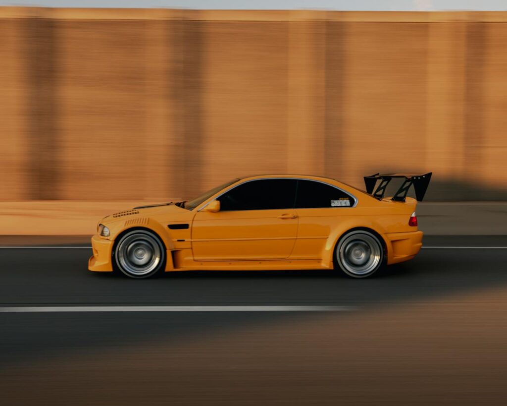 Yellow BMW E46 car speeding on an road in EST.